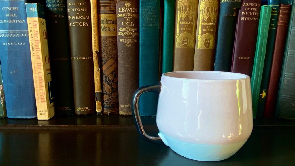 Image of cup with vintage books. 