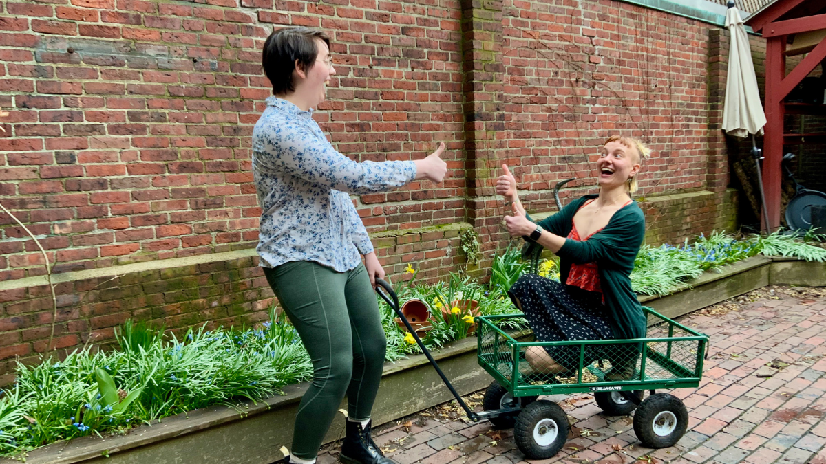 Program Fellows Cat Green (left) and Sofia Post (right) having fun at a photo shoot for our spring print newsletter.