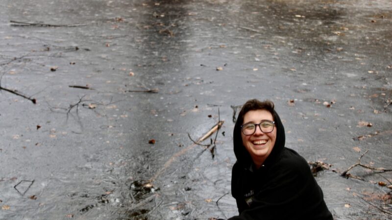 Photo: Micah Rensunberg by a frozen pond at the Woolman Hill Retreat Center.